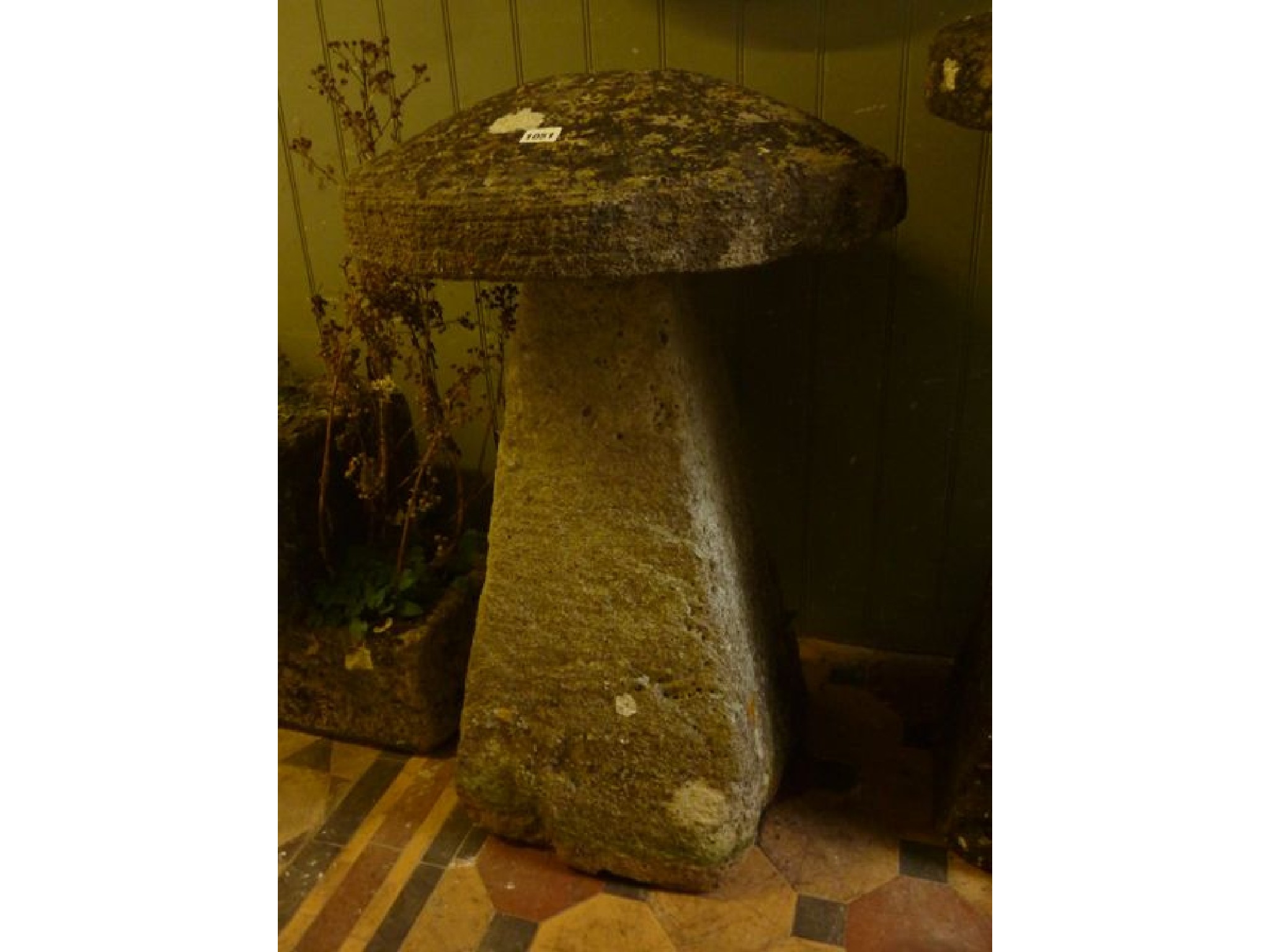 Appraisal: A weathered natural stone staddle stone and domed cap