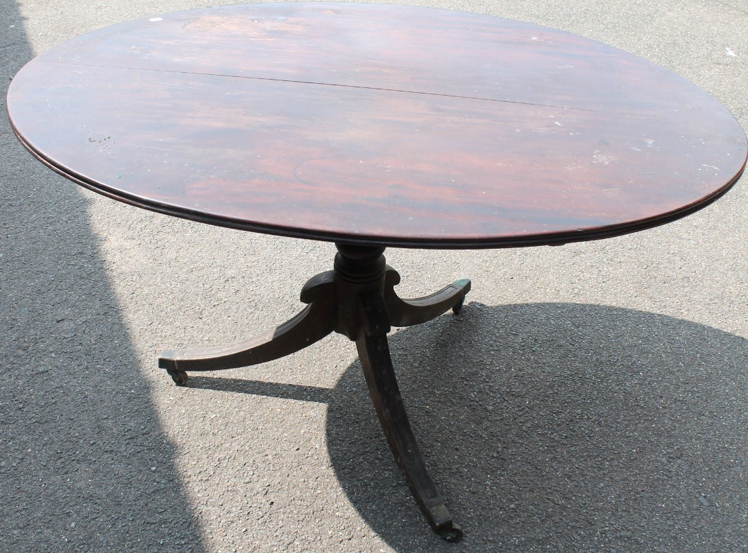 Appraisal: A thC oval breakfast table the tilt top on a