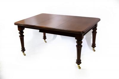 Appraisal: A Victorian mahogany dining table with an extra leaf on