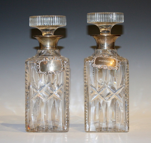 Appraisal: A PAIR OF CUT GLASS SPIRIT DECANTERS with star stoppers