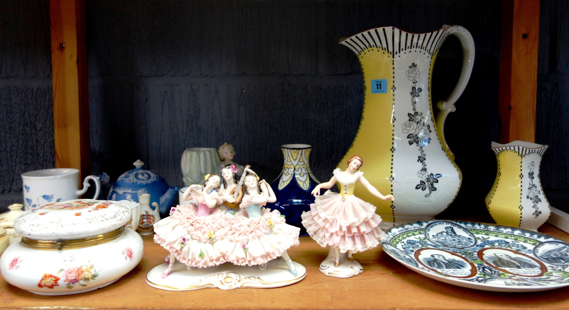 Appraisal: A Dresden porcelain crinoline figure a similar figure group a