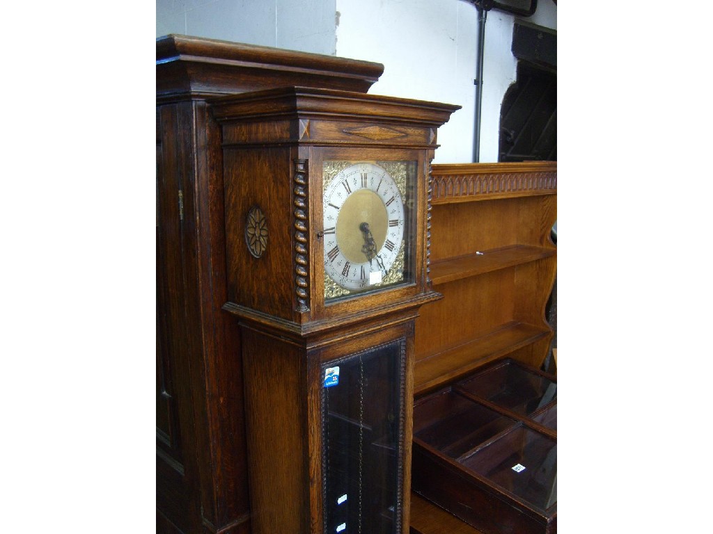 Appraisal: An Edwardian oak longcase clock with glazed panel door spiral