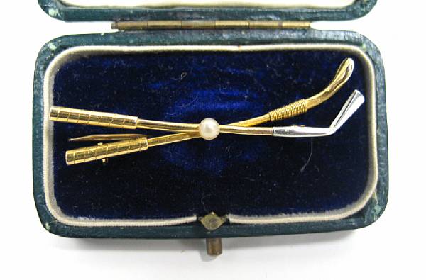 Appraisal: A gold and pearl golf brooch comprising two clubs and