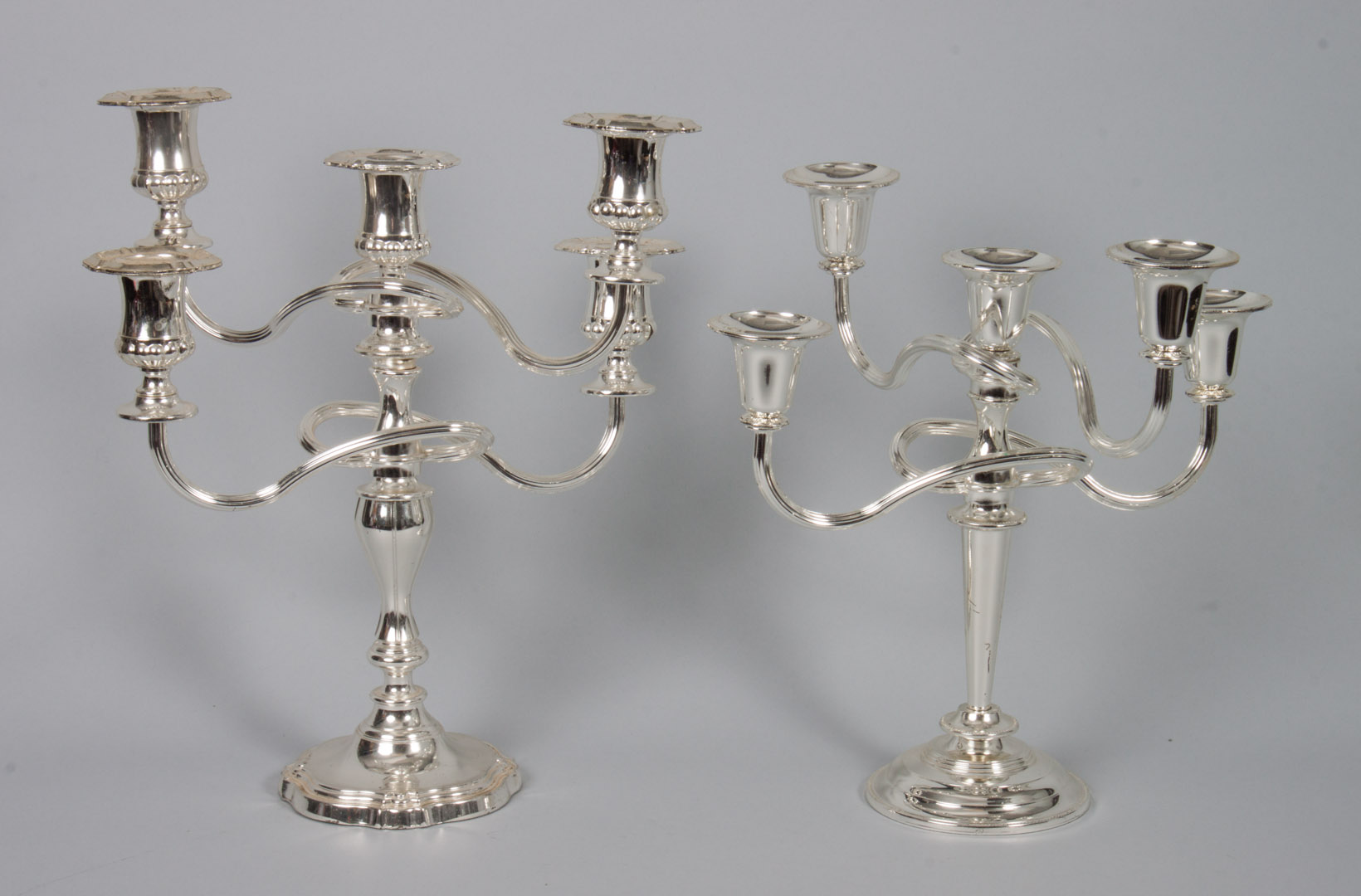 Appraisal: Two silver-plated candelabra mismatched the tallest in H