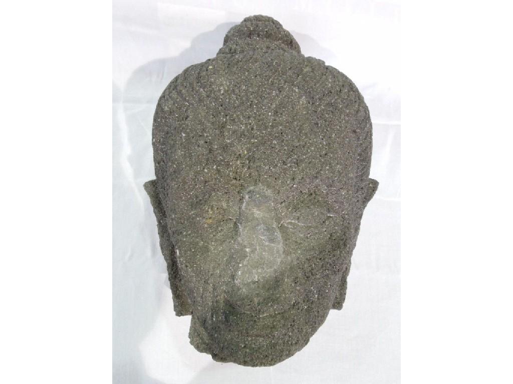 Appraisal: The head of a Buddha carved from volcanic stone in