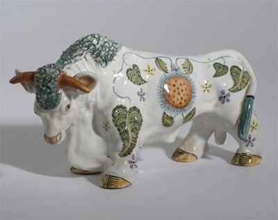 Appraisal: A Basil Mathews pottery model of a cow painted with