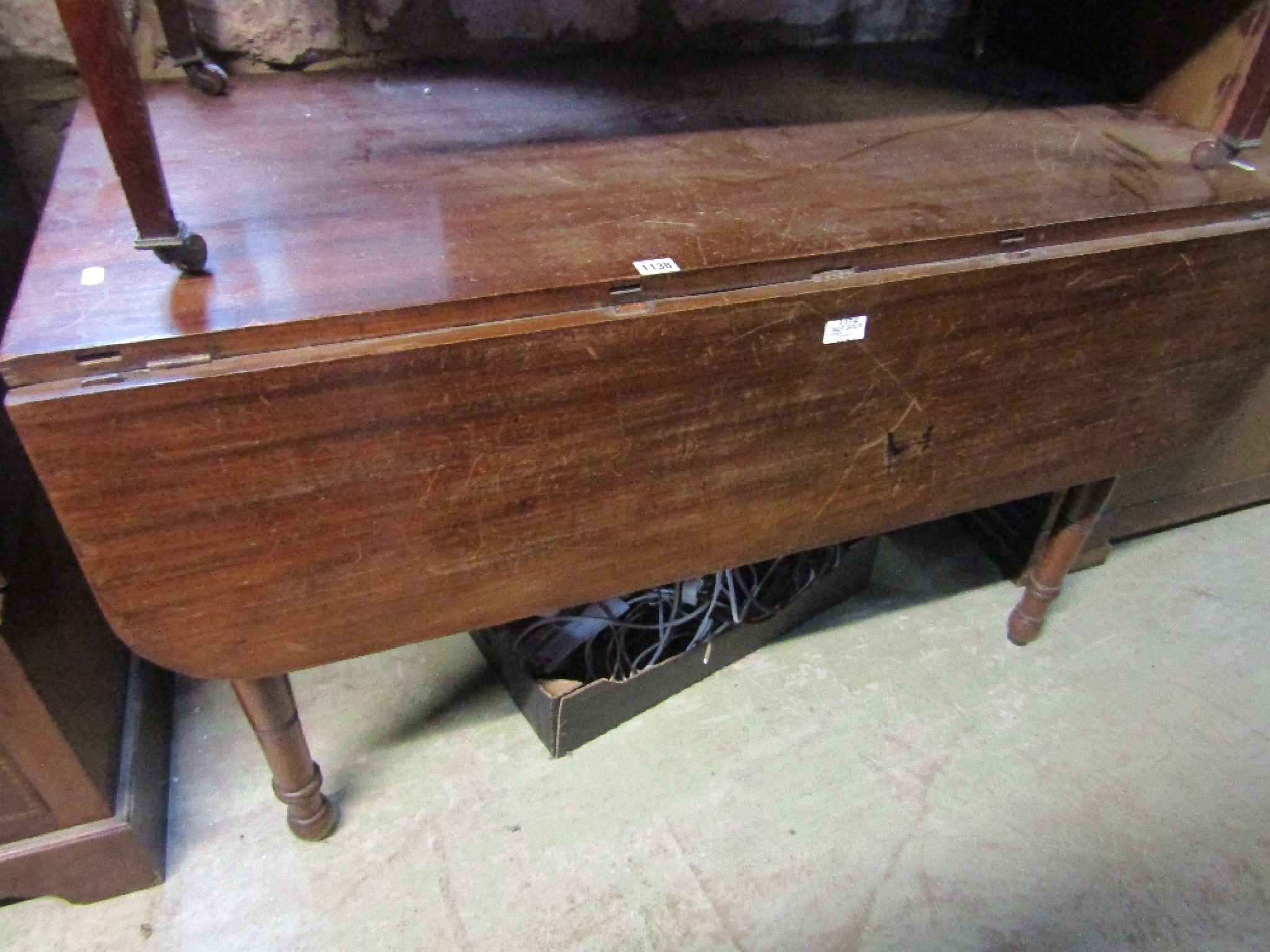 Appraisal: A large oversized mahogany Pembroke table with frieze drawer raised