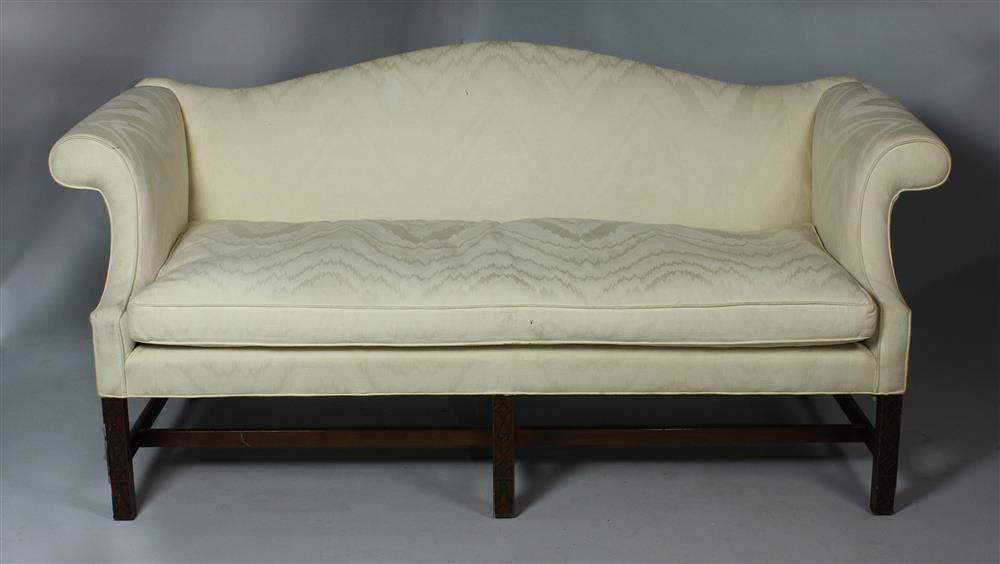 Appraisal: CHIPPENDALE STYLE CARVED MAHOGANY CAMELBACK SOFA the arching crest with