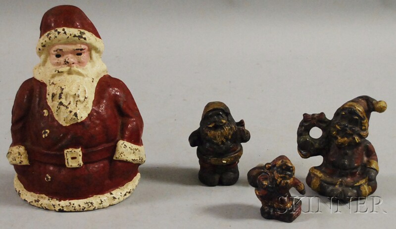 Appraisal: Four Painted Cast Iron Santa Claus Figural Doorstops and Paperweights