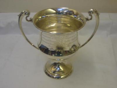 Appraisal: A TROPHY CUP of waisted form with leaf capped scroll