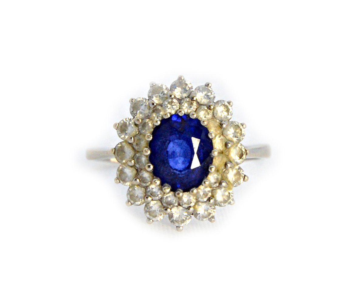 Appraisal: A white gold sapphire and diamond set oval cluster ring