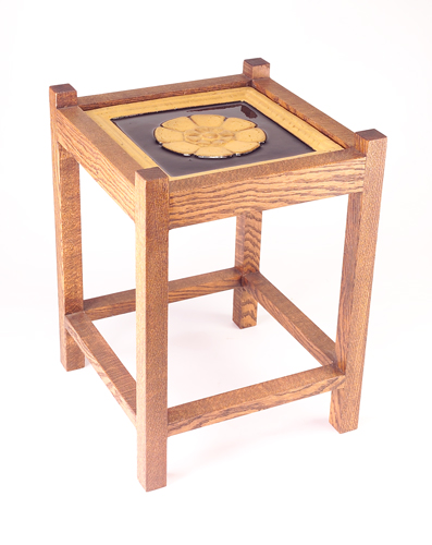 Appraisal: GRUEBY Tile-top table with one black and mustard floral tile