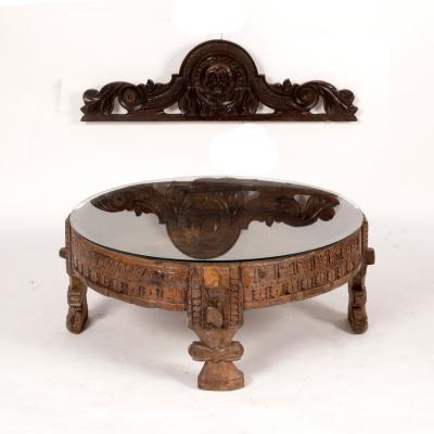 Appraisal: An Indian circular carved drum-top table on carved supports the