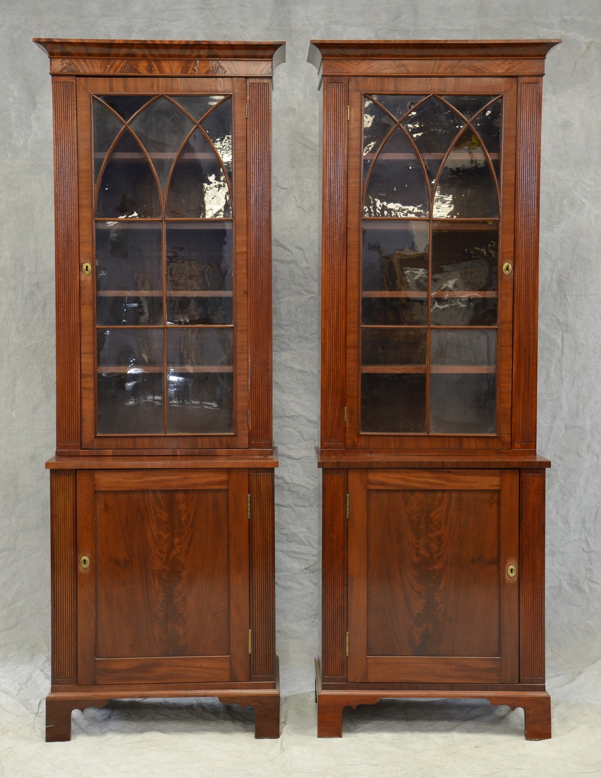 Appraisal: Pair of mahogany Georgian style two-piece display cabinets top section