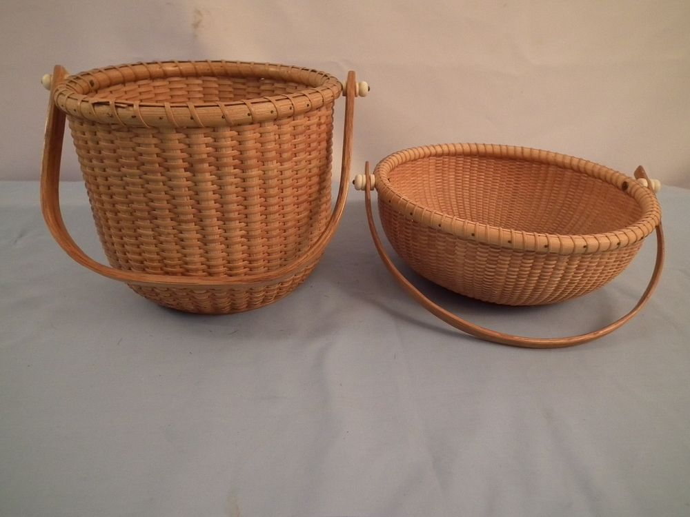 Appraisal: LAMONT NANTUCKET BASKETS Pair of vintage Nantucket baskets with swing