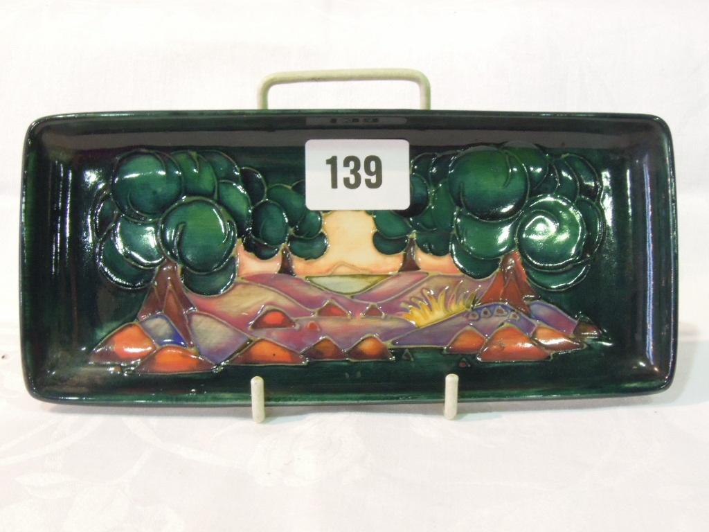 Appraisal: A Moorcroft green ground tray of rectangular form with stylised