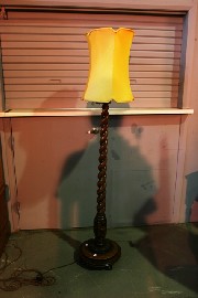 Appraisal: A stained oak lamp with Jacobean support and shade