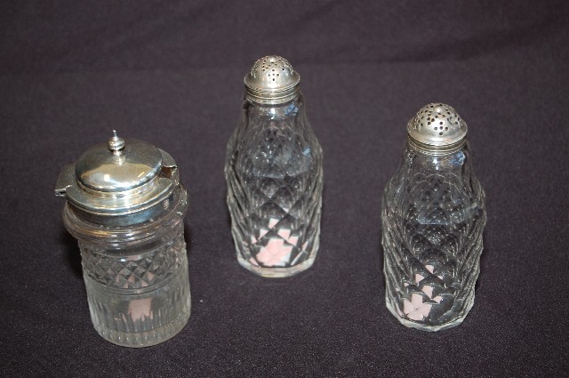 Appraisal: THREE GEORGIAN STERLING SILVER MOUNTED CRUET BOTTLES