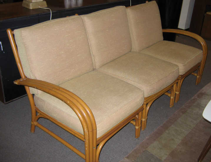 Appraisal: TWO-PIECE RATTAN ENSEMBLE Three-section settee l and an open armchair