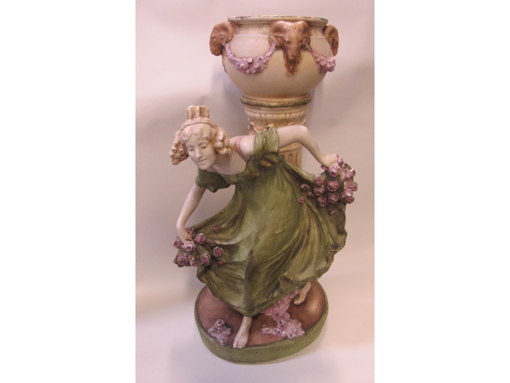 Appraisal: Austrian ceramic centrepiece of a maiden beside a jardiniere on