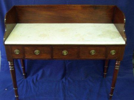 Appraisal: A George IV mahogany washstand with three-quarter gallery and marble