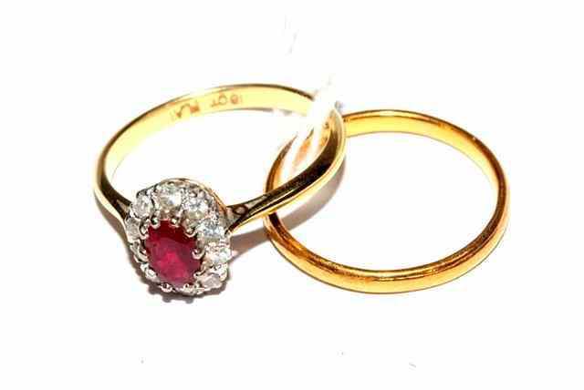 Appraisal: A RUBY AND DIAMOND SET OVAL CLUSTER RING claw set