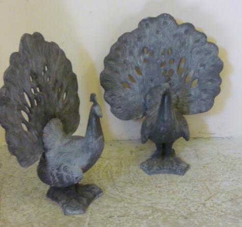 Appraisal: A PAIR OF LEAD PEACOCKS th century modelled standing with