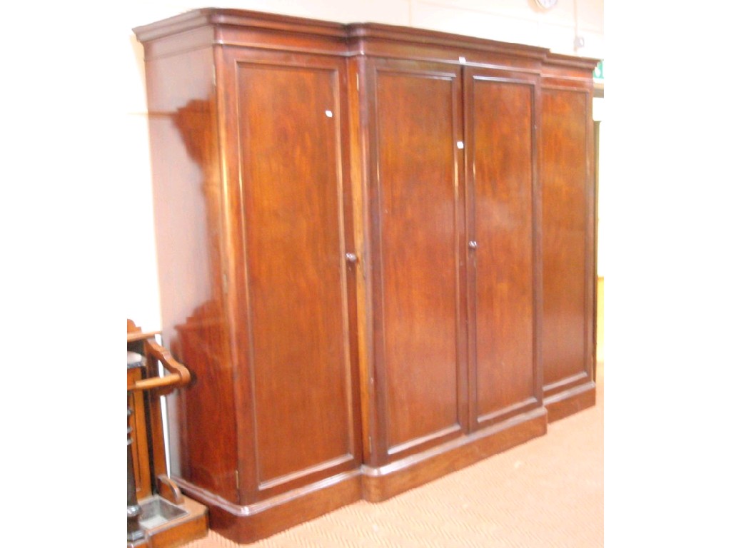 Appraisal: A Victorian figured mahogany breakfront linen press of three compartments