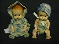 Appraisal: PAIR HARD PLASTIC BABIES Painted features crochet clothing Size inches