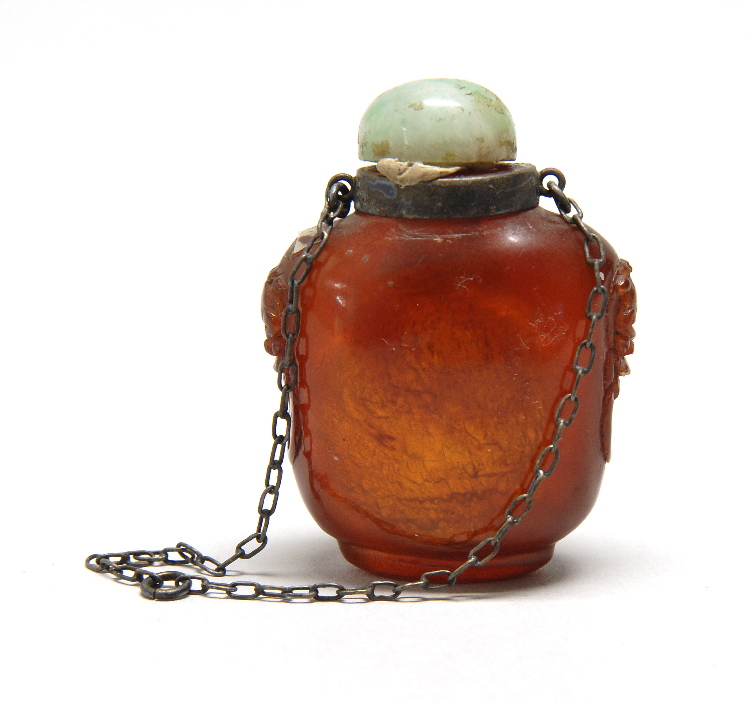 Appraisal: MINIATURE AMBER SNUFF BOTTLE In spade shape with lion's-head and