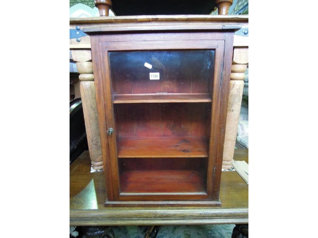 Appraisal: A small stained pine mahogany display cabinet enclosed by a