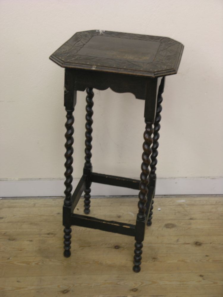 Appraisal: A solid dark oak plant stand with carved top on