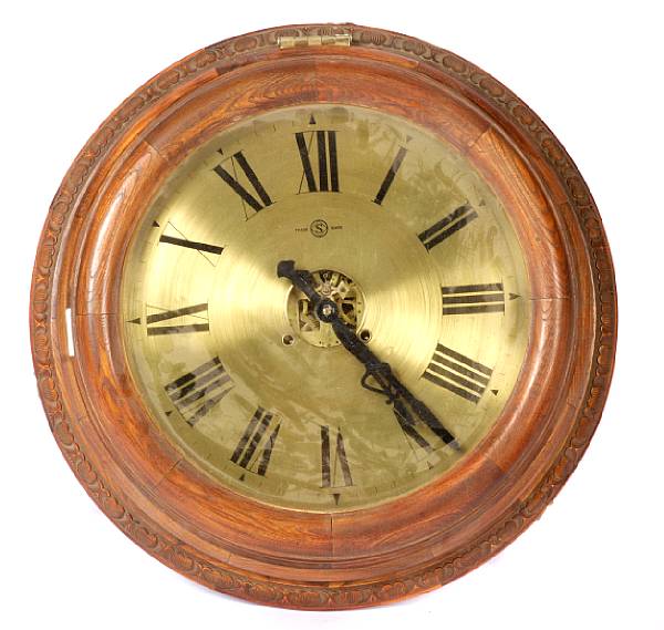 Appraisal: An oak circular wall clock with brass dial diameter in