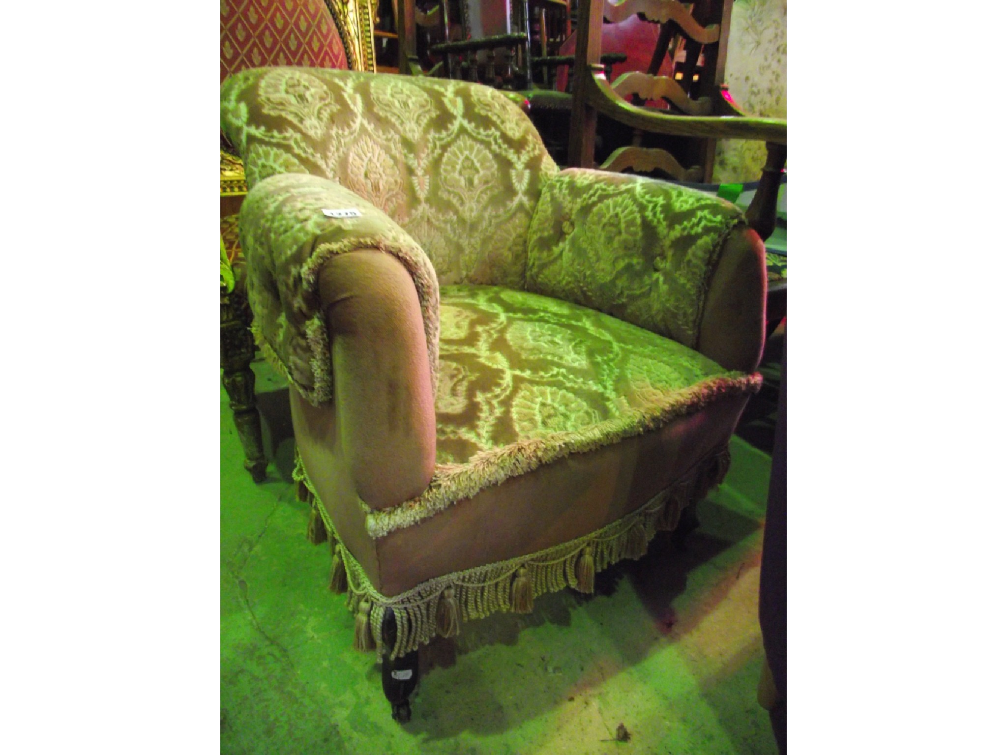 Appraisal: An Edwardian armchair with shaped outline upholstered finish and cabriole