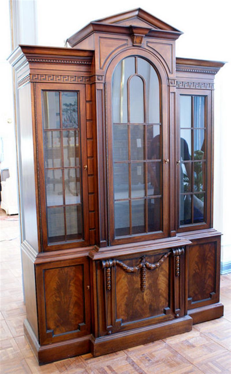 Appraisal: Mahogany one piece Georgian style breakfront with applied drapery carving