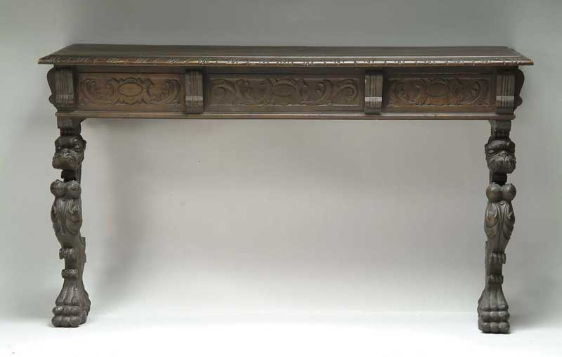 Appraisal: CARVED LION DECORATED CONSOLE TABLE Carved molded edge rectangular top