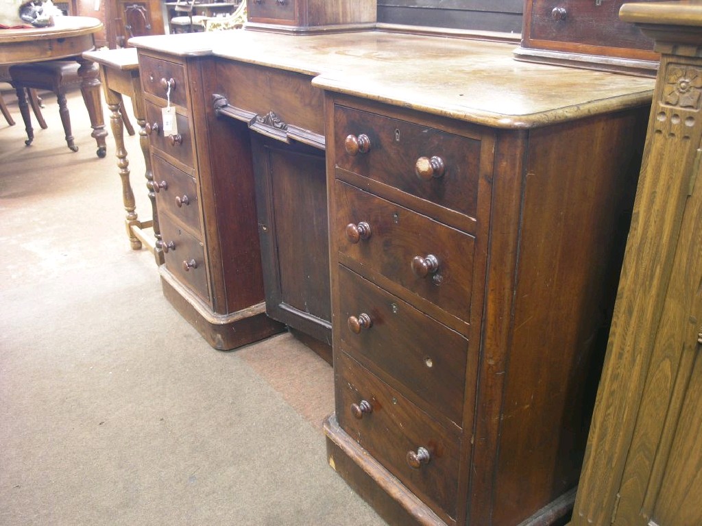 Appraisal: A Victorian mahogany desk the top fitted with two pairs