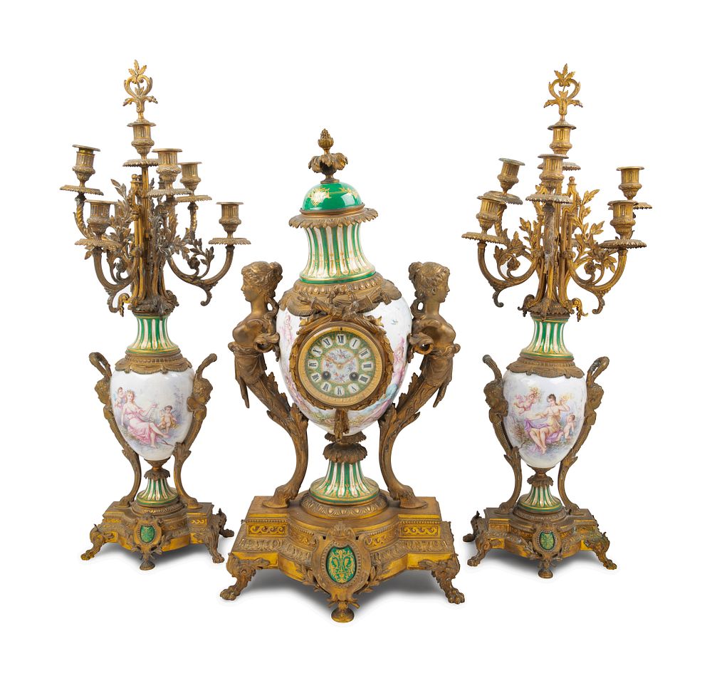 Appraisal: A Sevres Style Gilt Bronze Mounted Porcelain Clock Garniture Retailed