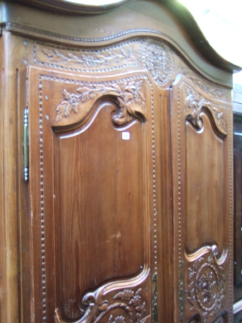 Appraisal: A th century French carved pine armoire with arched top