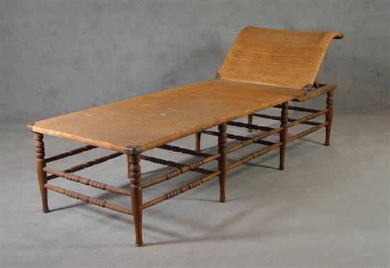 Appraisal: Turned Wooden Day Bed Early th Century Hinged rattan platform