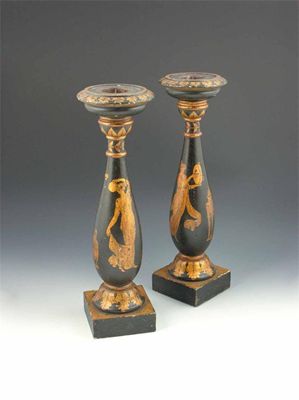 Appraisal: A pair of ebonised and parcel gilt carved wood candlesticks