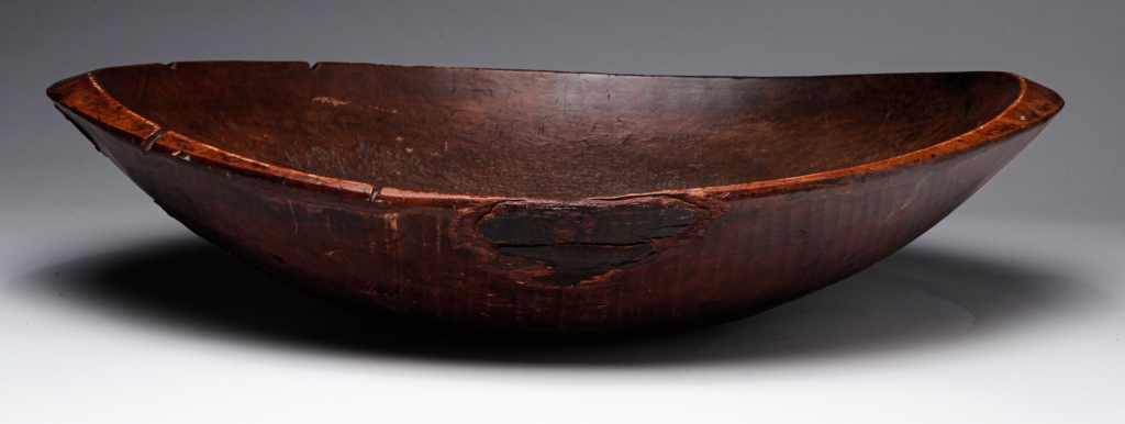 Appraisal: AMERICAN TRENCHER Nineteenth century Oblong rough hewn bowl with edge