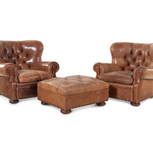 Appraisal: A Pair of Leather Upholstered Wingback Armchairs with Ottoman Retailed