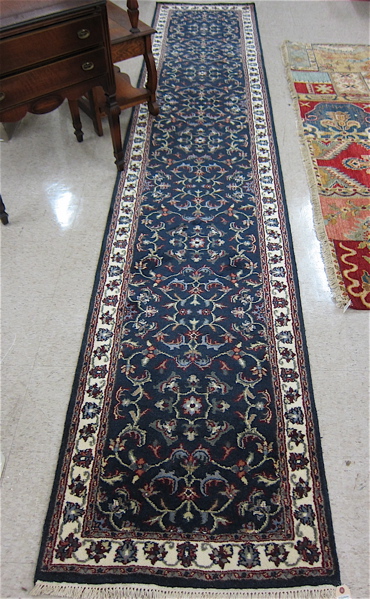 Appraisal: HAND KNOTTED ORIENTAL HALL CARPET Indo-Persian meandering vine decoration on