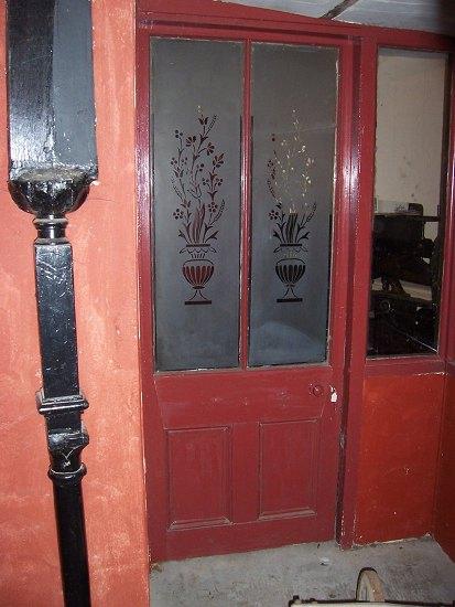 Appraisal: A door with twin acid etched panes decorated vases of