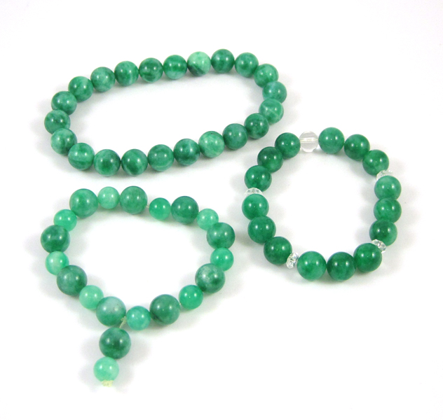 Appraisal: THREE GREEN HARDSTONE BRACELETS including a - inch stretch bracelet