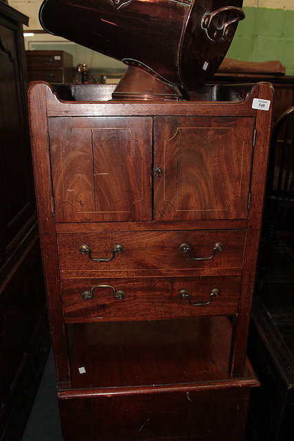 Appraisal: A GEORGIAN MAHOGANY TRAY TOP WASHSTAND with two cupboard doors