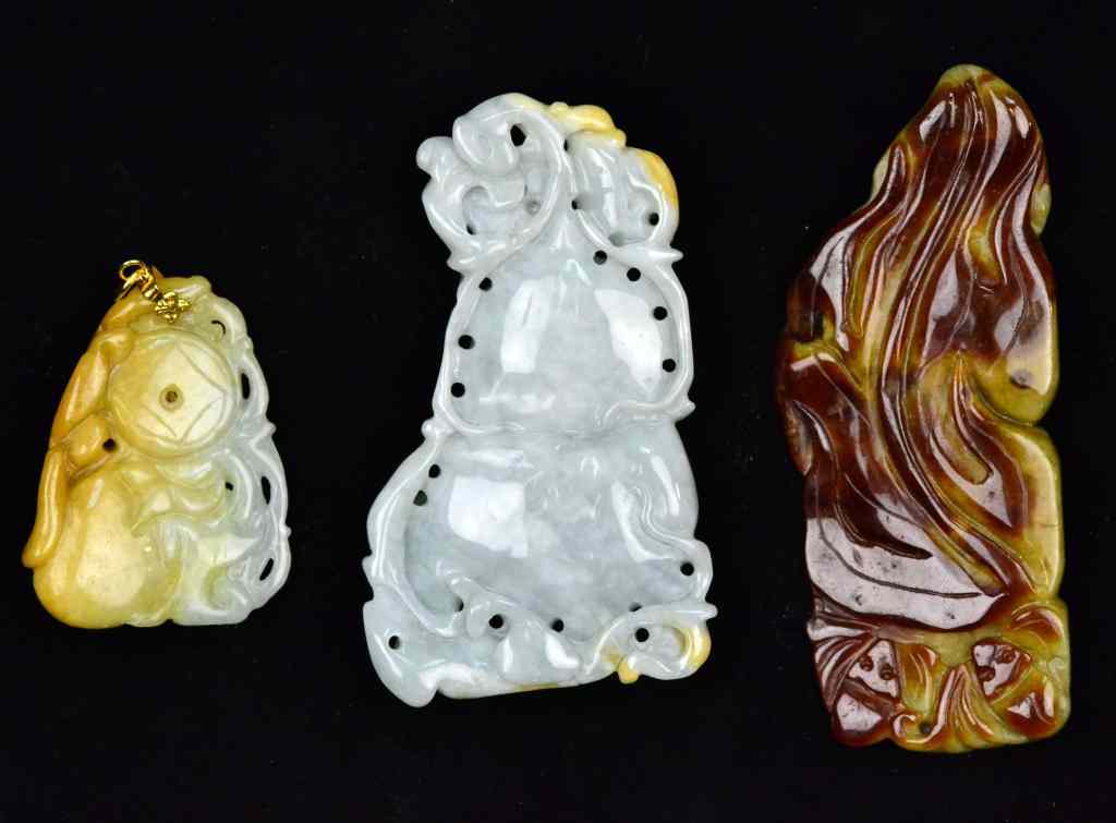 Appraisal: Chinese Qing Carved Jade PendantsFinely carved to depict fruit and