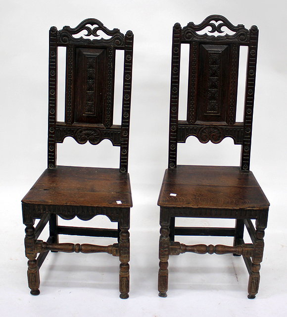 Appraisal: A PAIR OF ANTIQUE CARVED OAK CHAIRS with panelled back