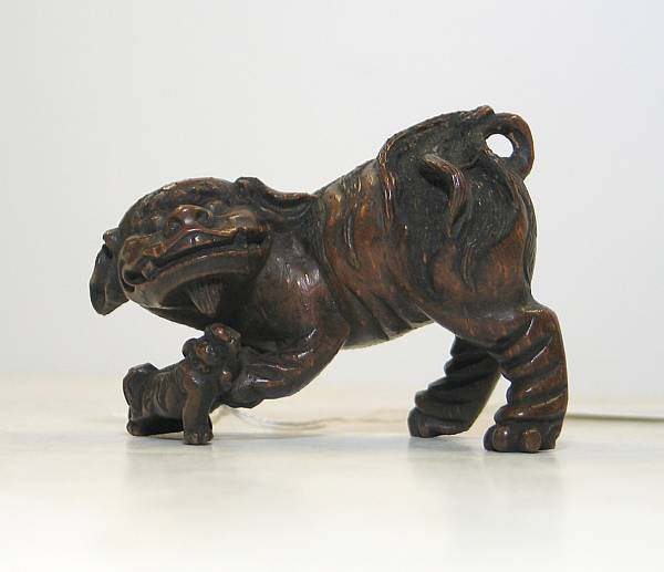 Appraisal: A carved bamboo figure of a lioness and cub Qing